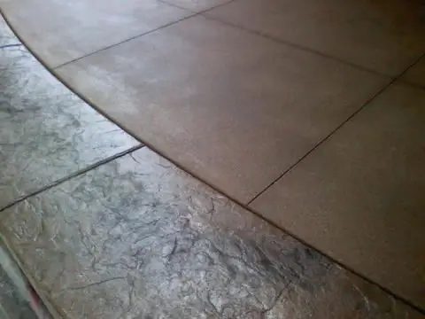 Stamped texture with a curved control joint