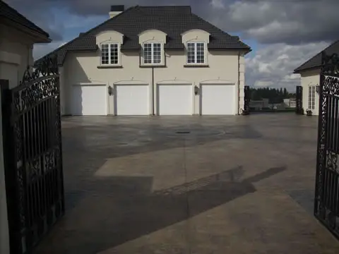 Colored driveway and motor court with iron gates