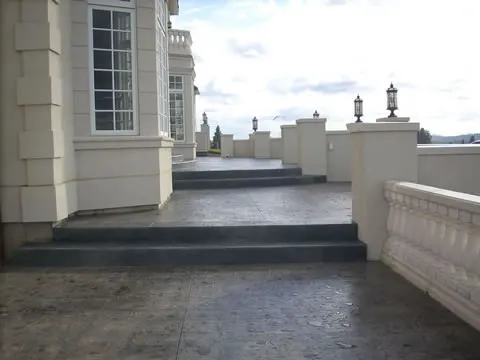 Colored concrete patio with white balustrade overlooking the Spokane valley
