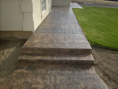 Stamped concrete steps down to the lawn