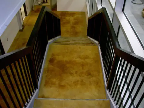 Stained concrete stairway with iron railing