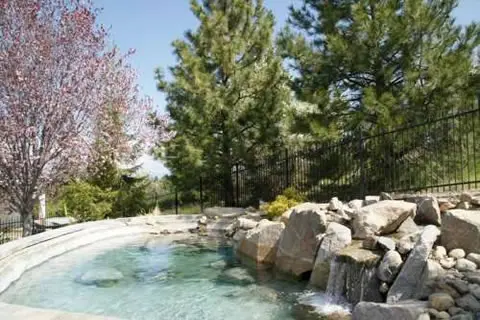 Pool deck with natural stone water feature