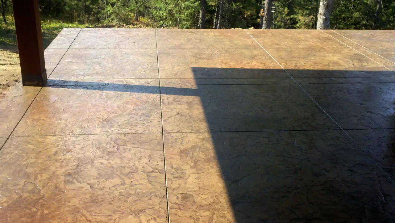 Colored and stamped patio slab in afternoon light
